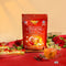 A package of Wisconsin American Ginseng Assorted Root Tea on a red tablecloth with flowers around.