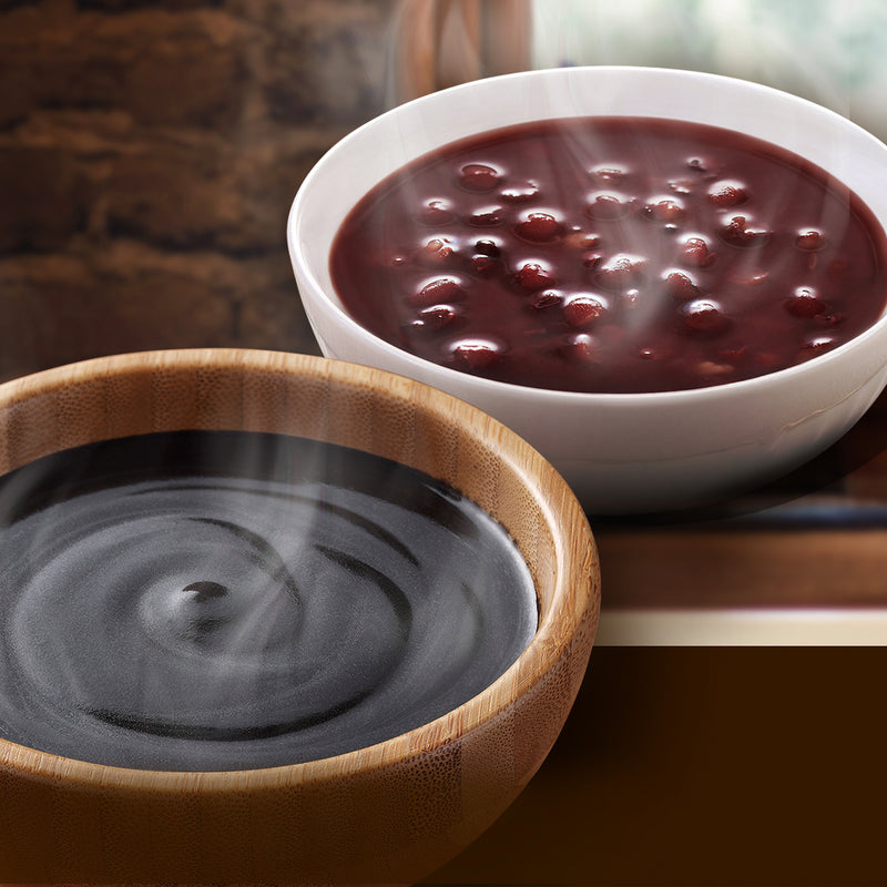 A bowl of Wing Wah Black Sesame Dessert and a bowl of Wing Wah red been dessert on a table.